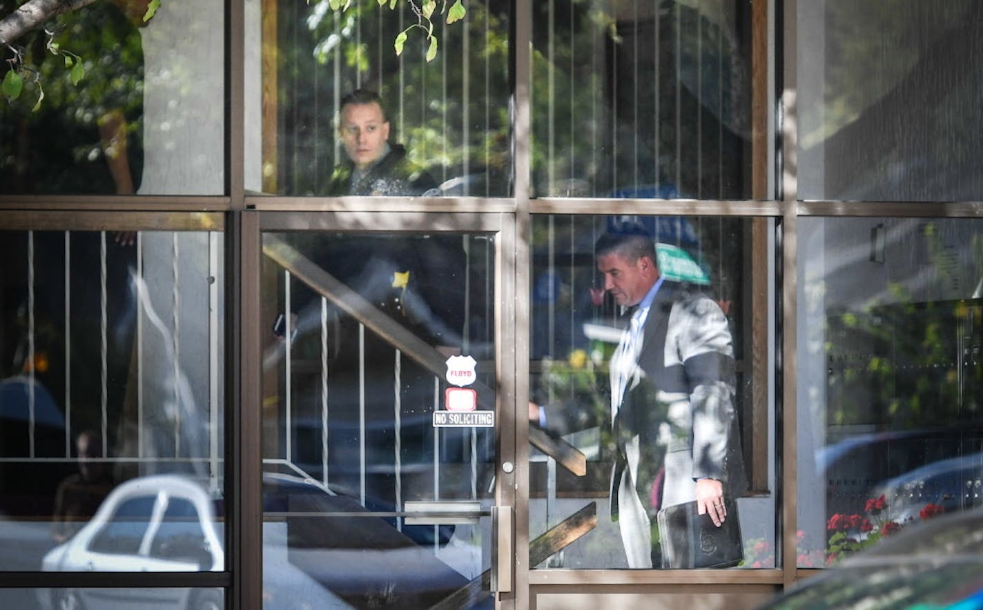 Police spokesperson Corey Schmidt and Commander Erick Fors in the front lobby of the apartment building that was the scene of a shooting that left three people dead and one injured on the 5400 block of 34th Ave. S.