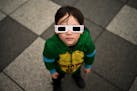 Owen Kloncz, 4, looks up to the sky to try to find the sun and the solar eclipse on Monday at the Science Museum of Minnesota in St. Paul.