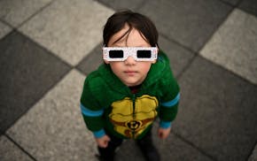 Owen Kloncz, 4, looks up to the sky to try to find the sun and the solar eclipse on Monday at the Science Museum of Minnesota in St. Paul.