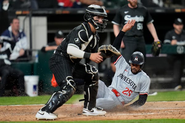The Twins' Byron Buxton slides into home with the go-ahead run in a 3-2 victory after a single by Max Kepler in the ninth inning against the White Sox