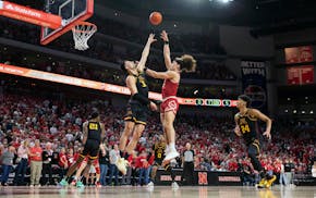 Nebraska's Josiah Allick, center right, shot against the Gophers' Dawson Garcia, center left, during the first half Sunday in Lincoln, Neb.