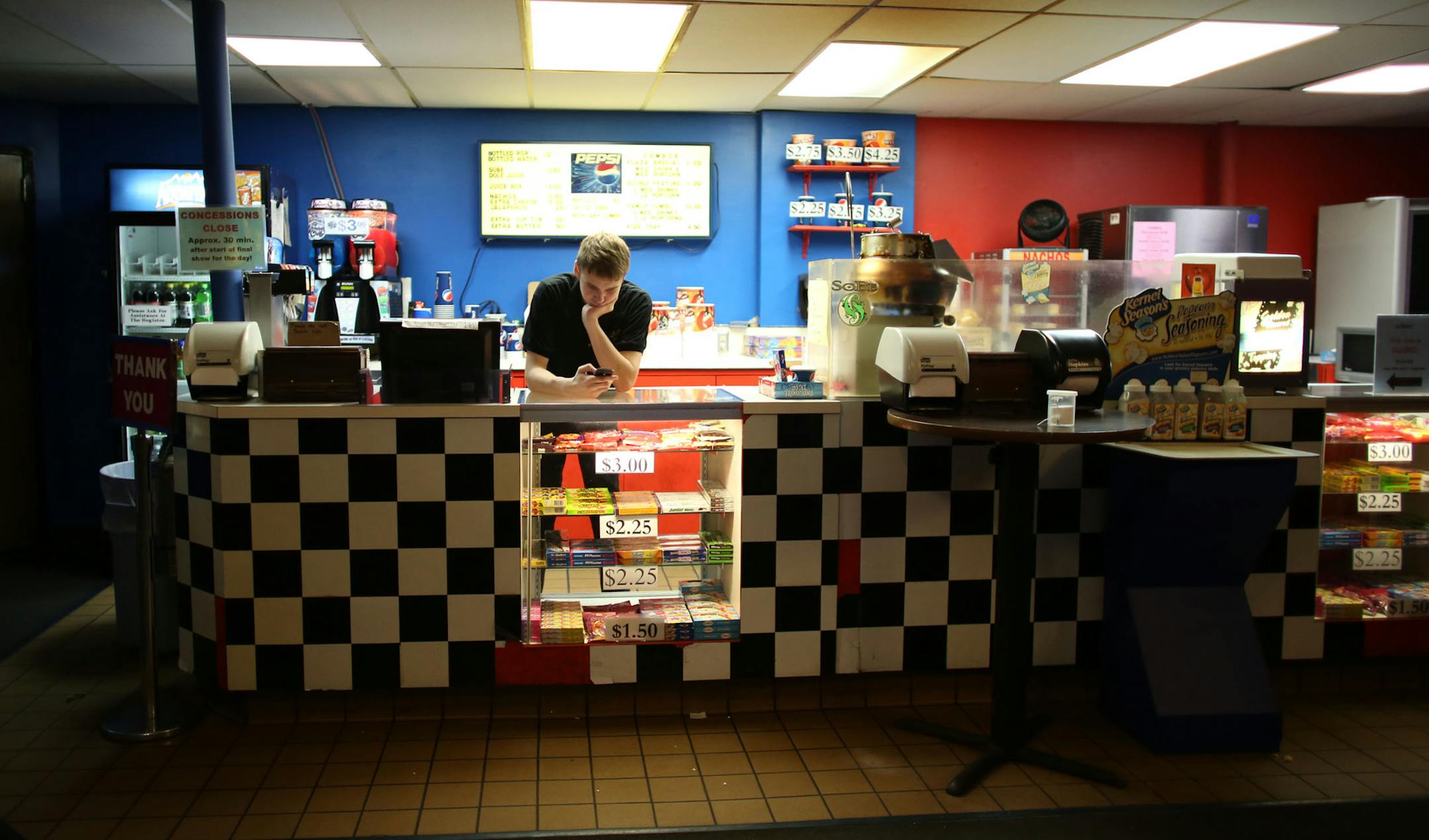 Nick Whelan checked his email as he waited for customers at the Plaza Maplewood Theatre, in Maplewood Min., Thursday, October 3, 2013 ] (KYNDELL HARKNESS/STAR TRIBUNE) kyndell.harkness@startribune.com
