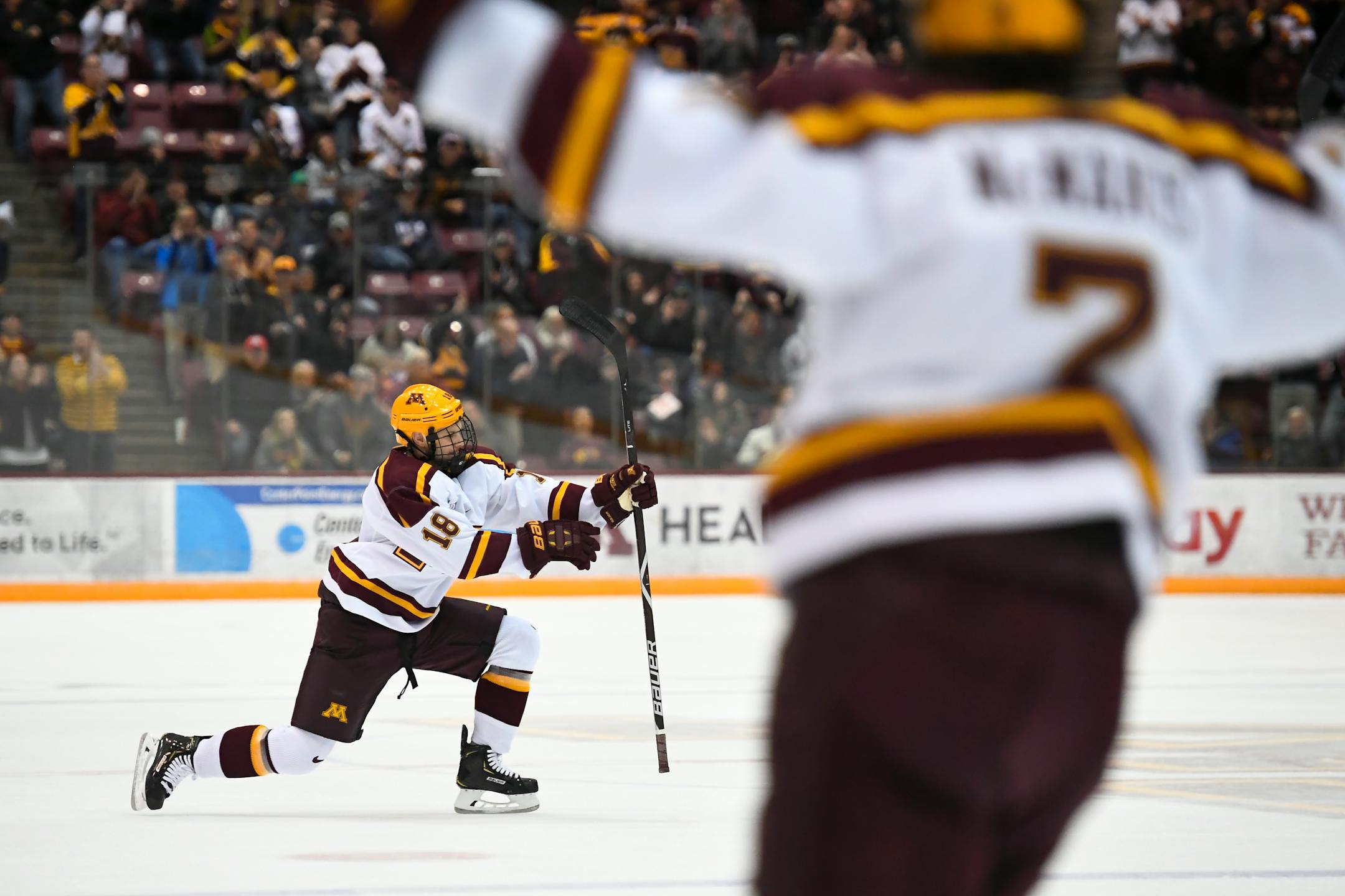 Minnesota defenseman Clayton Phillips (18) and forward Brannon McManus (7) celebrate McManus' second goal of the night off an assist by Phillips in the first period