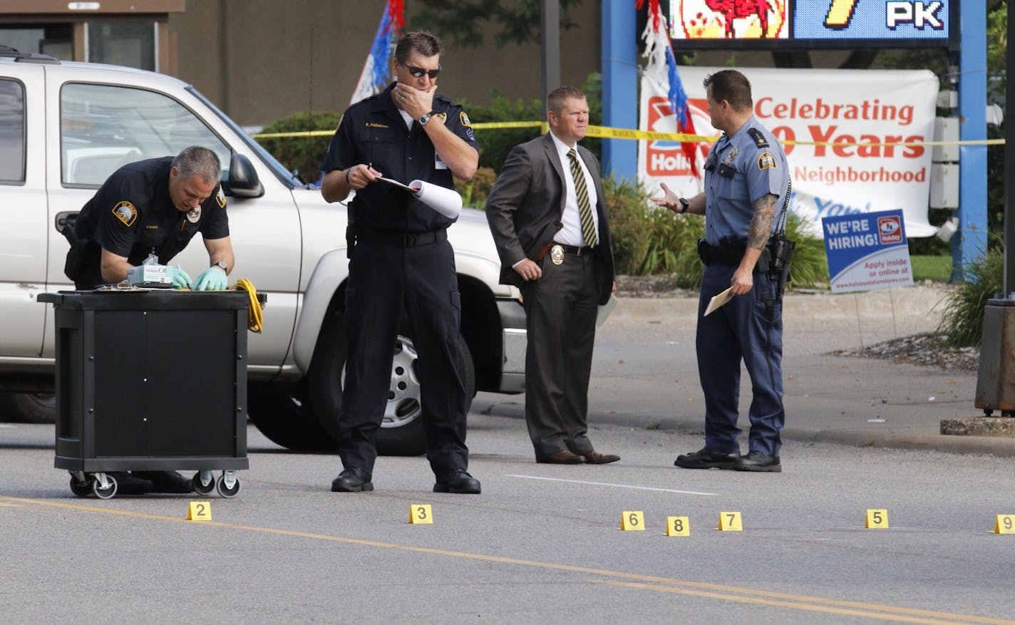 St. Paul police investigators analyzed the scene at Wabasha and Plato, where a suspect allegedly involved in vandalism was shot and killed by police.