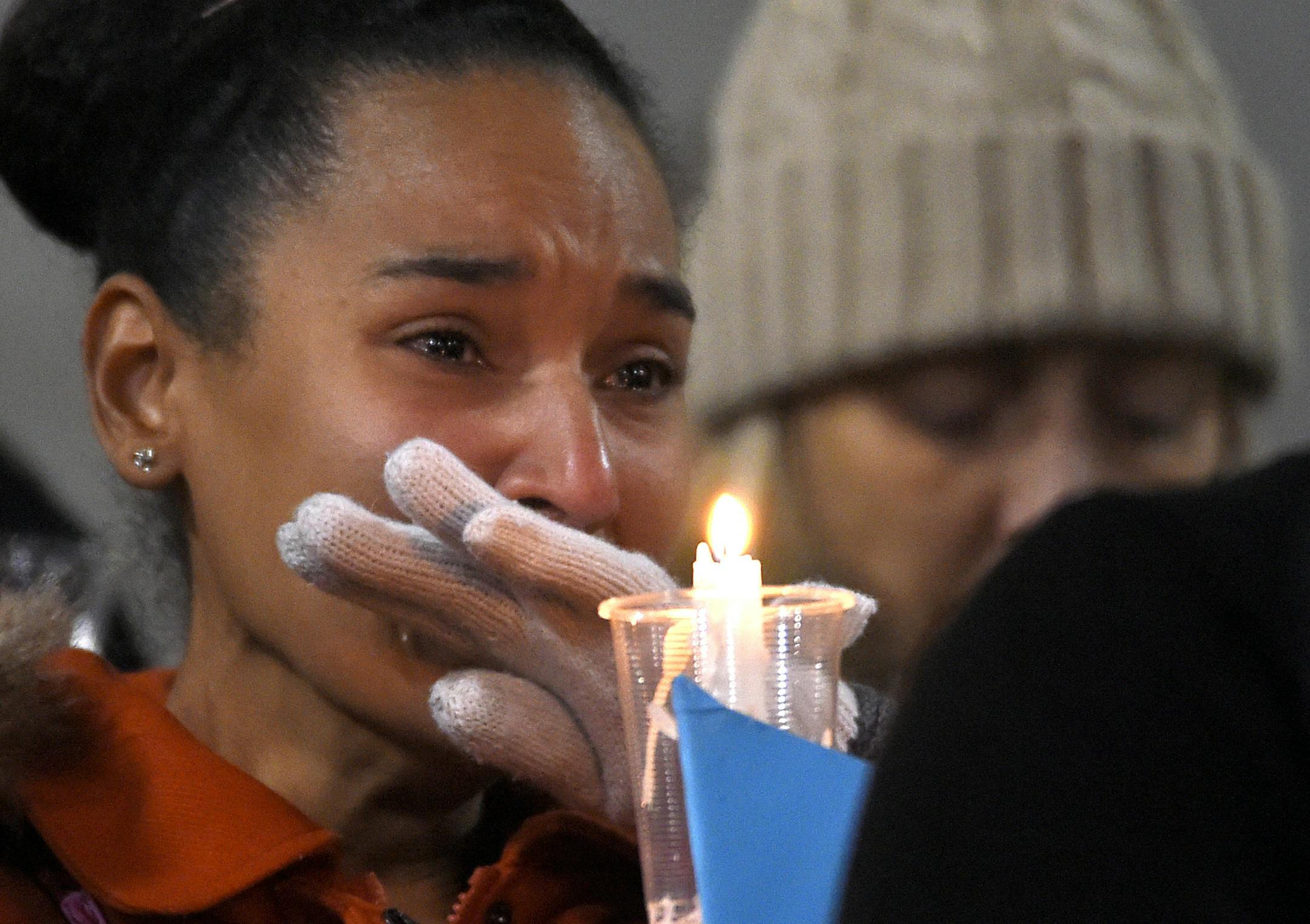 A woman cries during a candlelight vigil at San Manuel Stadium, Thursday, Dec. 3, 2015, in San Bernardino, Calif. for multiple victims of a shooting that took place at a holiday banquet on Wednesday. A husband and wife opened fire killing multiple people. Hours later, the couple died in a shootout with police. (AP Photo/Mark J. Terrill)