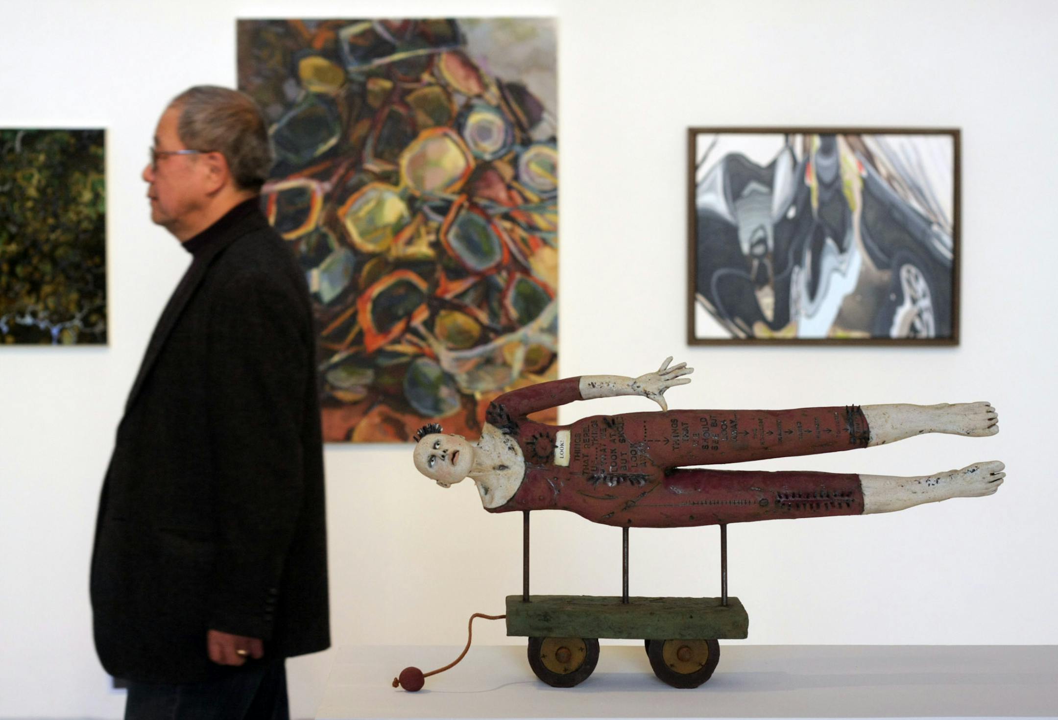 Kinji Akagawa tours the installation of " Paradigm Shift," a show at MCAD by alumni and friends honoring him.