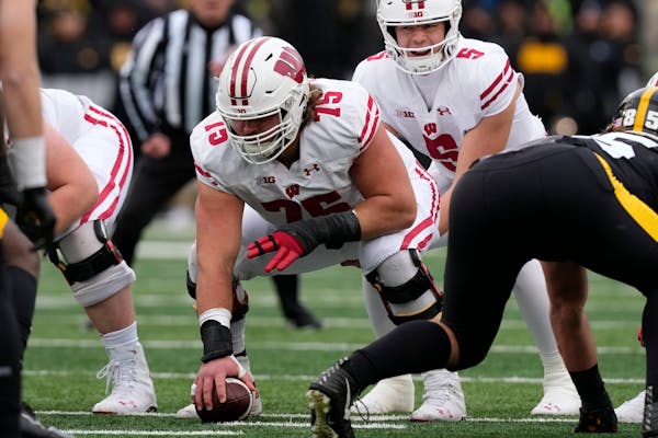 Wisconsin offensive lineman Joe Tippmann (75) gets set to snap the ball during the first half of an NCAA college football game against Iowa, Saturday,