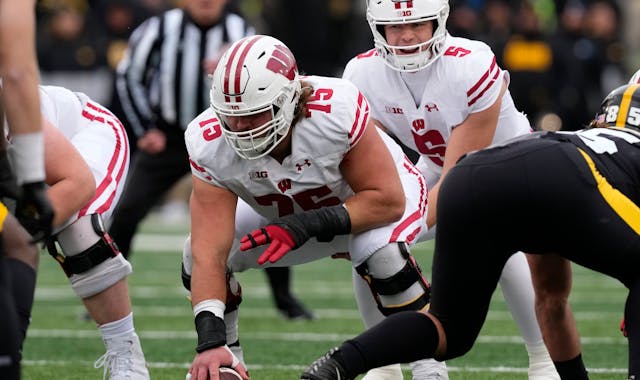 Wisconsin offensive lineman Joe Tippmann (75) gets set to snap the ball during the first half of an NCAA college football game against Iowa, Saturday,