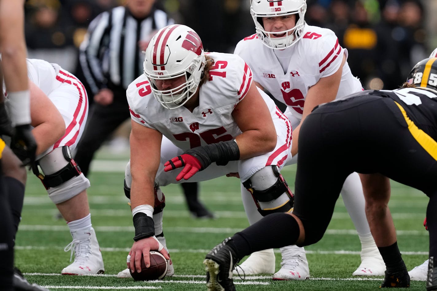 Wisconsin offensive lineman Joe Tippmann (75) gets set to snap the ball during the first half of an NCAA college football game against Iowa, Saturday, Nov. 12, 2022, in Iowa City, Iowa. (AP Photo/Charlie Neibergall)