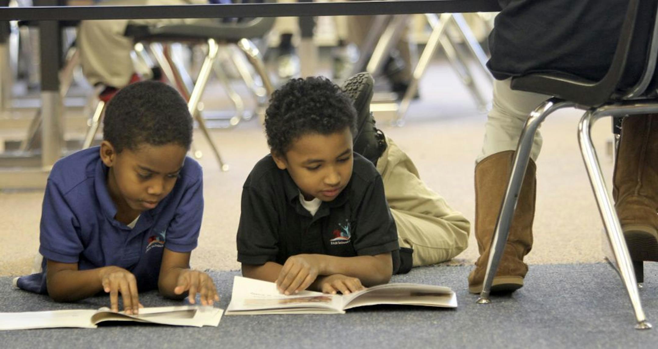 Third-graders Curtis Hatcher, left, and Kashawn Pierce read Tuesday at the FAIR school, operated by the West Metro Education Program, in Minneapolis. FAIR schools were started to promote integration across school district lines.