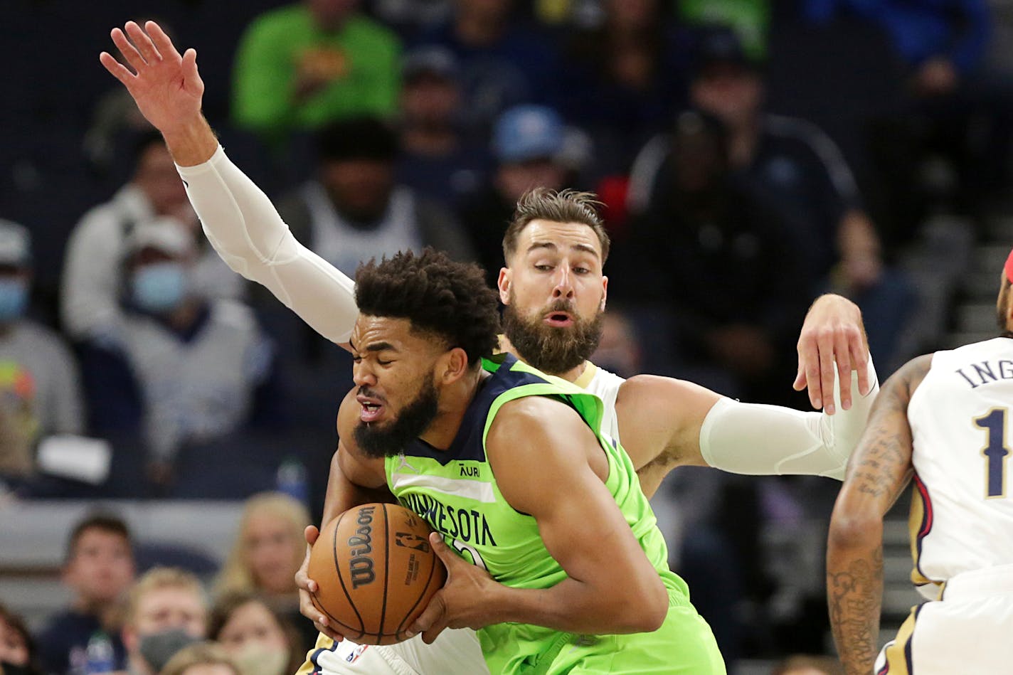 Minnesota Timberwolves center Karl-Anthony Towns (32) drives against New Orleans Pelicans center Jonas Valanciunas (17) in the first half of an NBA basketball game, Saturday, Oct. 23, 2021, in Minneapolis. (AP Photo/Andy Clayton-King)