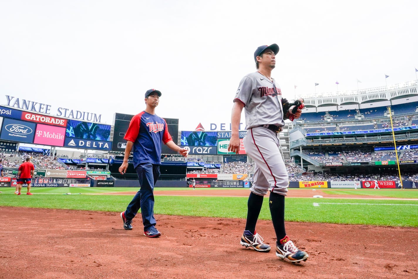 Minnesota Twins pitcher Kenta Maeda, right, before the start of a baseball game against the New York Yankees, Saturday, Aug. 21, 2021, in New York. (AP Photo/Mary Altaffer)