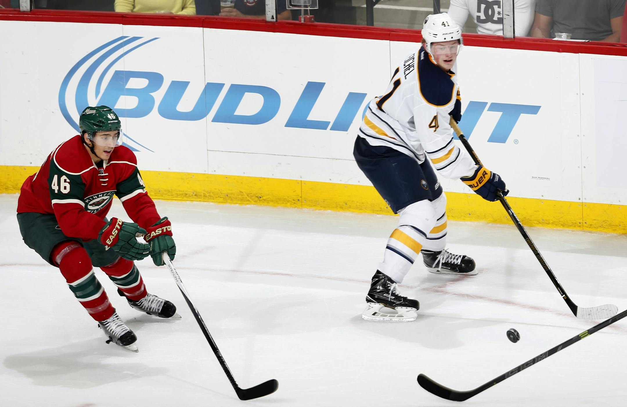 Jack Eichel (41) of the Buffalo Sabres and Jared Spurgeon (46) of the Minnesota Wild chased a loose puck in the second period.