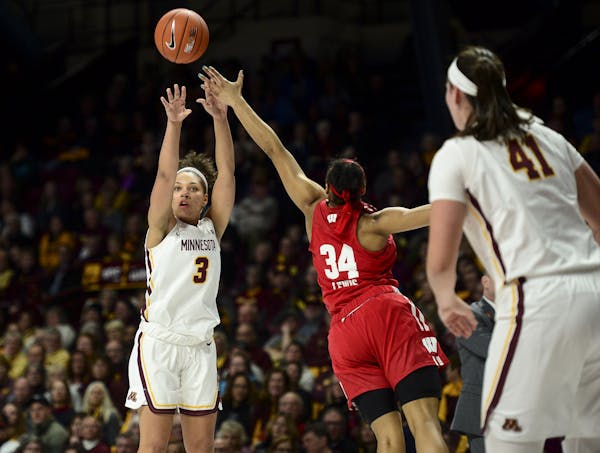 Minnesota Golden Gophers guard/forward Destiny Pitts (3) hit a 3-pointer while being defended by Wisconsin Badgers forward Imani Lewis (34).