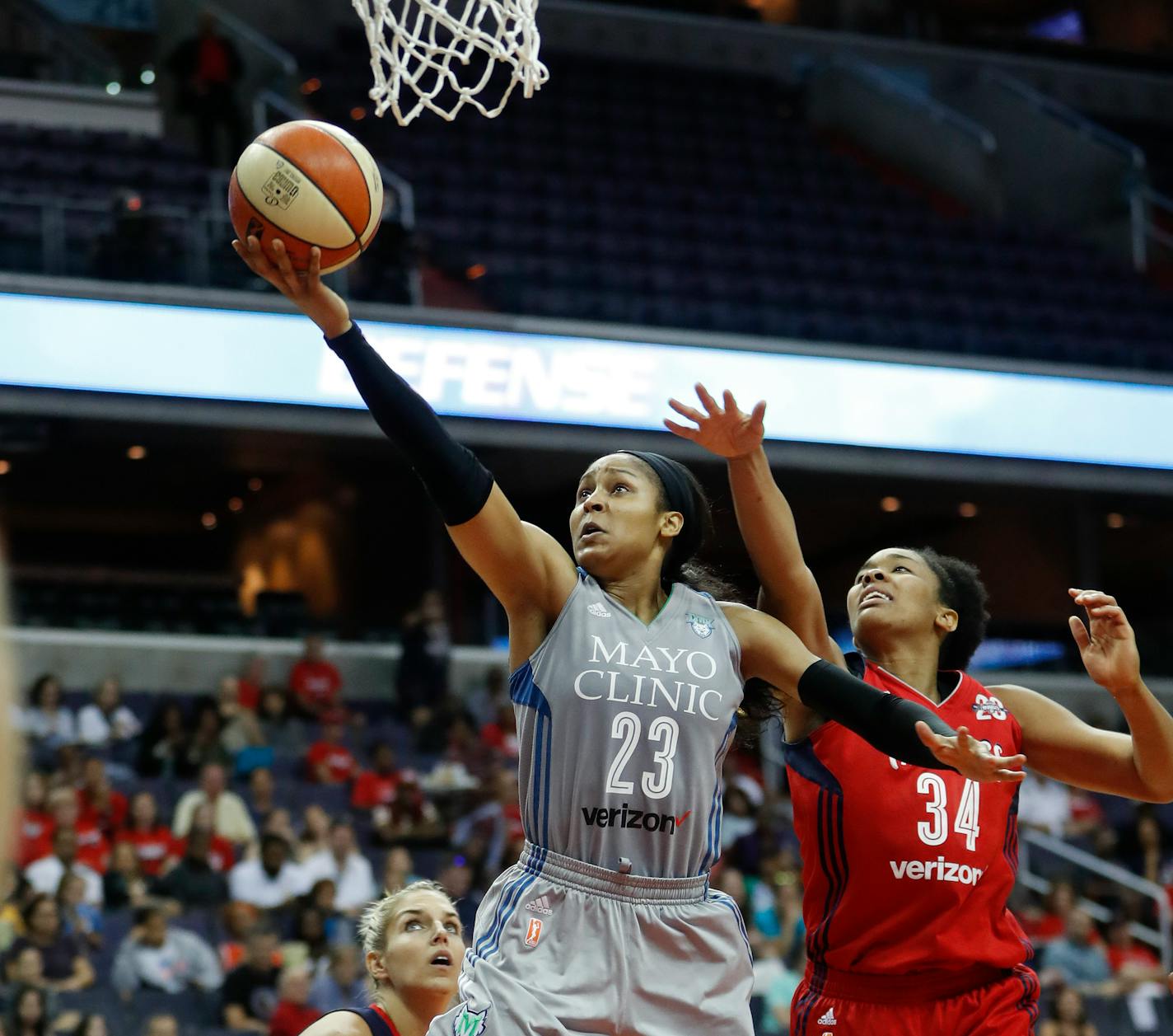 Lynx forward Maya Moore drives past Mystics guard Elena Delle Donne (11) and center Krystal Thomas (34) during the first half of Game 3