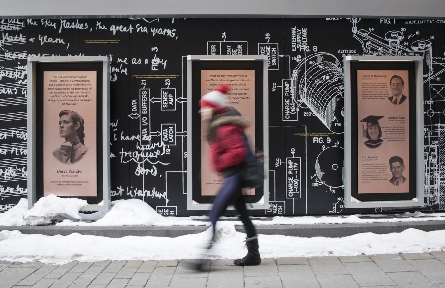 A student walks past a plaque with musician Dessa Wander's picture and story (left) on Scholars Walk at the University of Minnesota campus on Monday, February 12, 2018, in Minneapolis, Minn. That space used to house the Garrison Keillor plaque, which was recently removed.