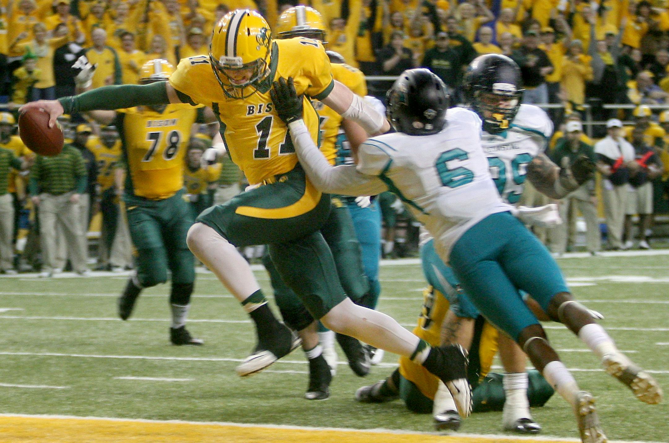 North Dakota State quaterback Carson Wentz, left, scores on a two-point conversion during the second half against Coastal Carolina in an FCS quarterfinal NCAA college football game Saturday, Dec. 13, 2014, in Fargo, N.D. (AP Photo/Bruce Crummy)