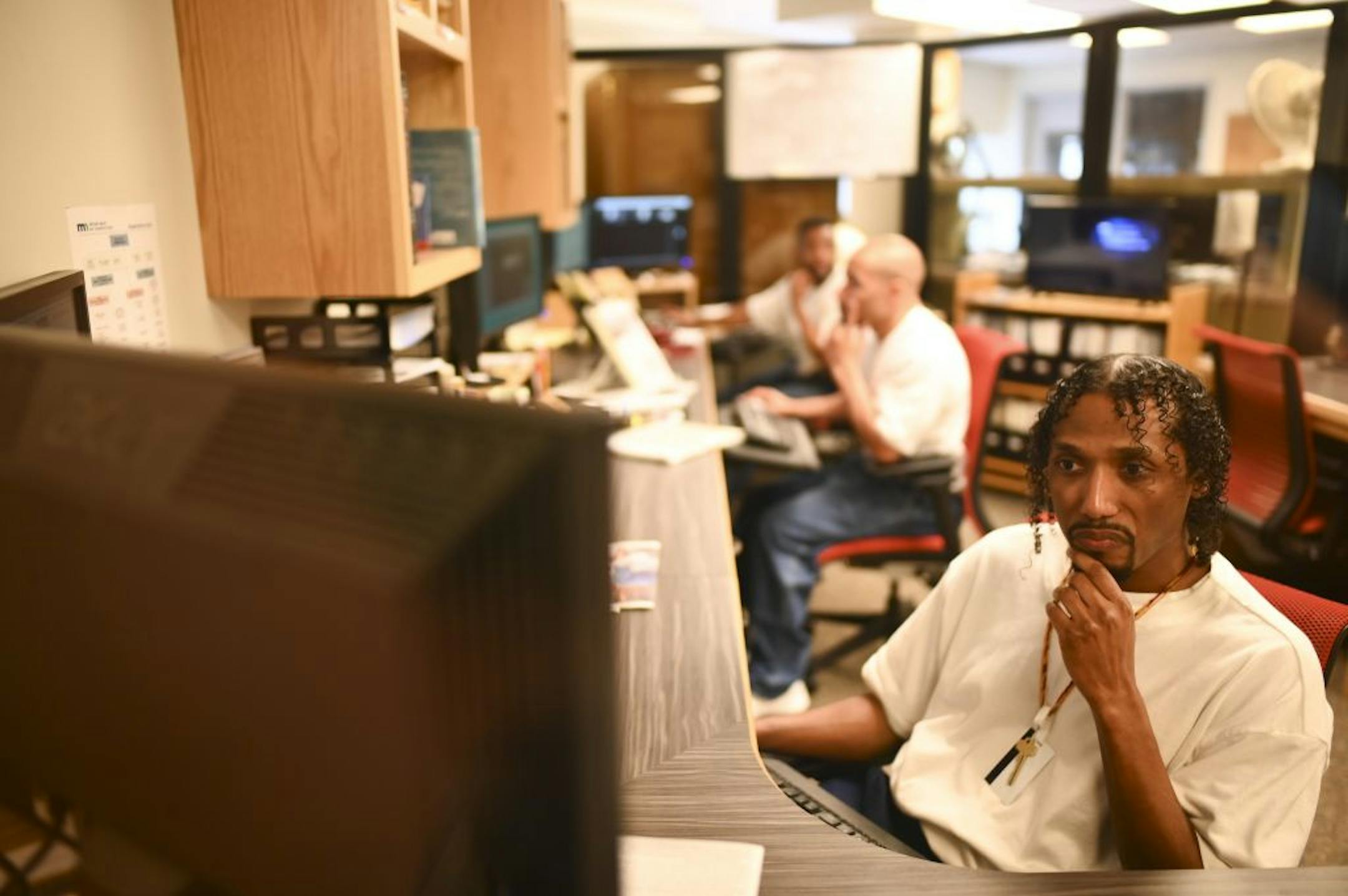Lennell Martin, right, worked alongside his co-editors of the Prison Mirror on producing the paper Wednesday.