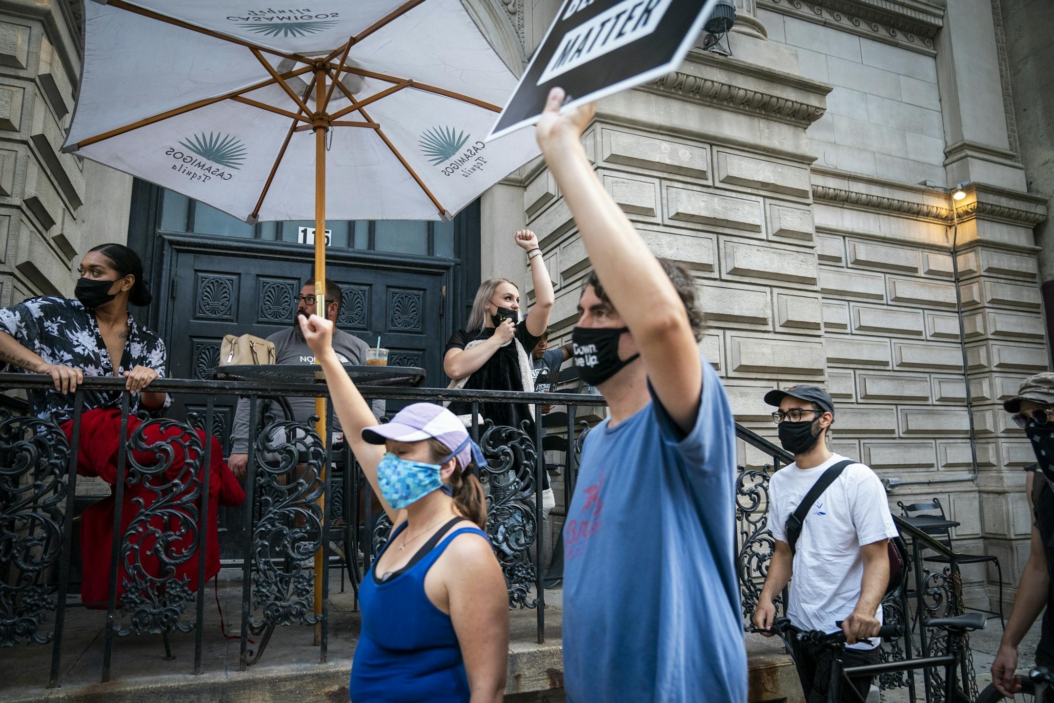 Protesters passed by strippers and workers taking a break outside Downtown Cabaret as they marched downtown from the Minneapolis Police Department's First Precinct back to Government Center.