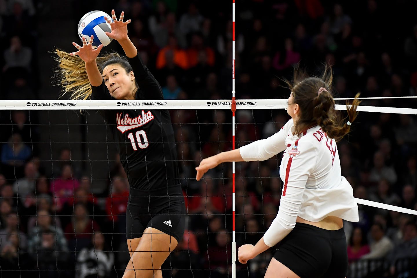 Stanford's Audriana Fitzmorris (12) spiked the ball past Nebraska outside hitter Lexi Sun