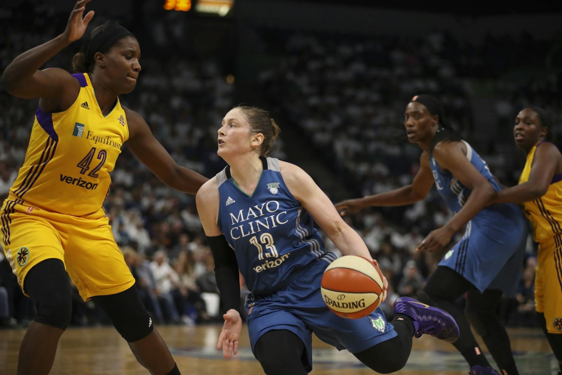 Minnesota Lynx guard Lindsay Whalen (13) drove to the net against Los Angeles Sparks center Jantel Lavender (42) in the third quarter.