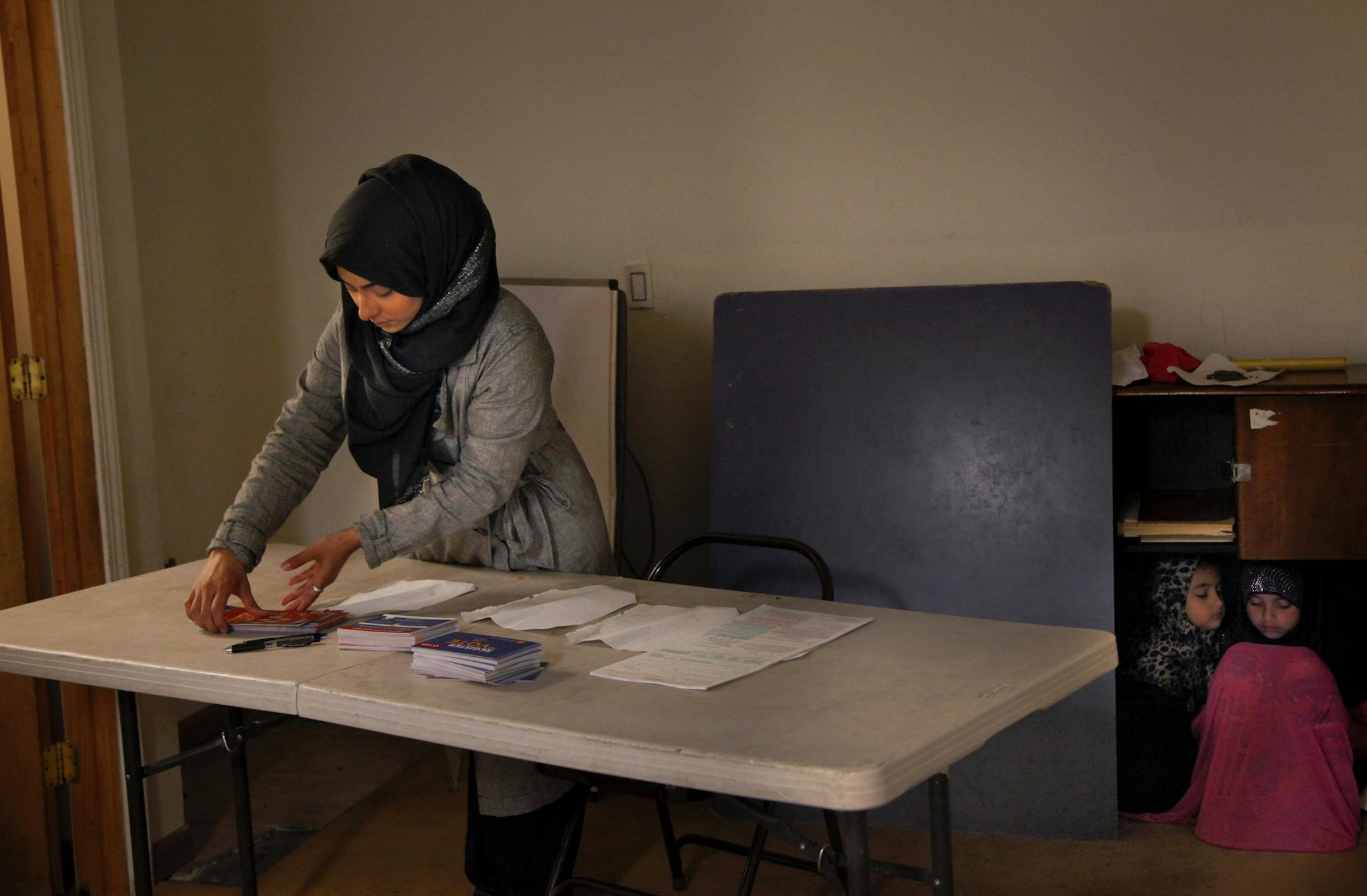 Jehan Hakim sets up a table for voter registration during a service at the Oakland Islamic Center in California, May 20, 2016. As the political climate becomes unsettling to many Muslims, some groups are hoping to galvanize the population to vote this November. (Preston Gannaway/The New York Times)