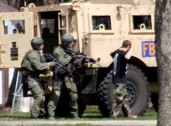 May 3, 2013: Authorities with Buford Rogers, right, during a raid on a mobile home in Montevideo, Minn.