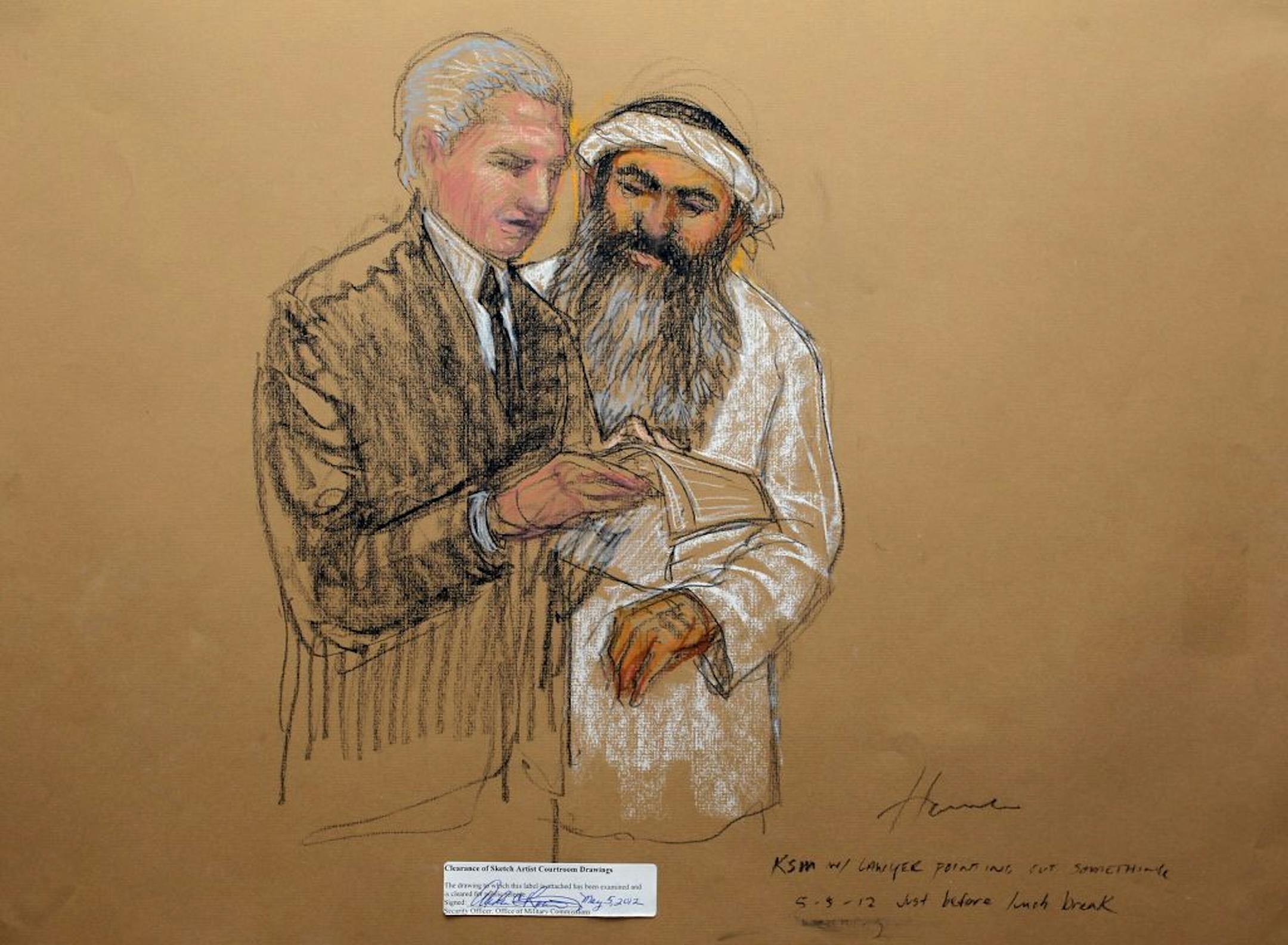 Accused 9/11 mastermind Khalid Sheik Mohammed, right, consults defense attorney civilian David Nevin, in this courtroom sketch, during a break at his military commission hearing in Guantanamo Bay, Cuba, Saturday, May 5, 2012.