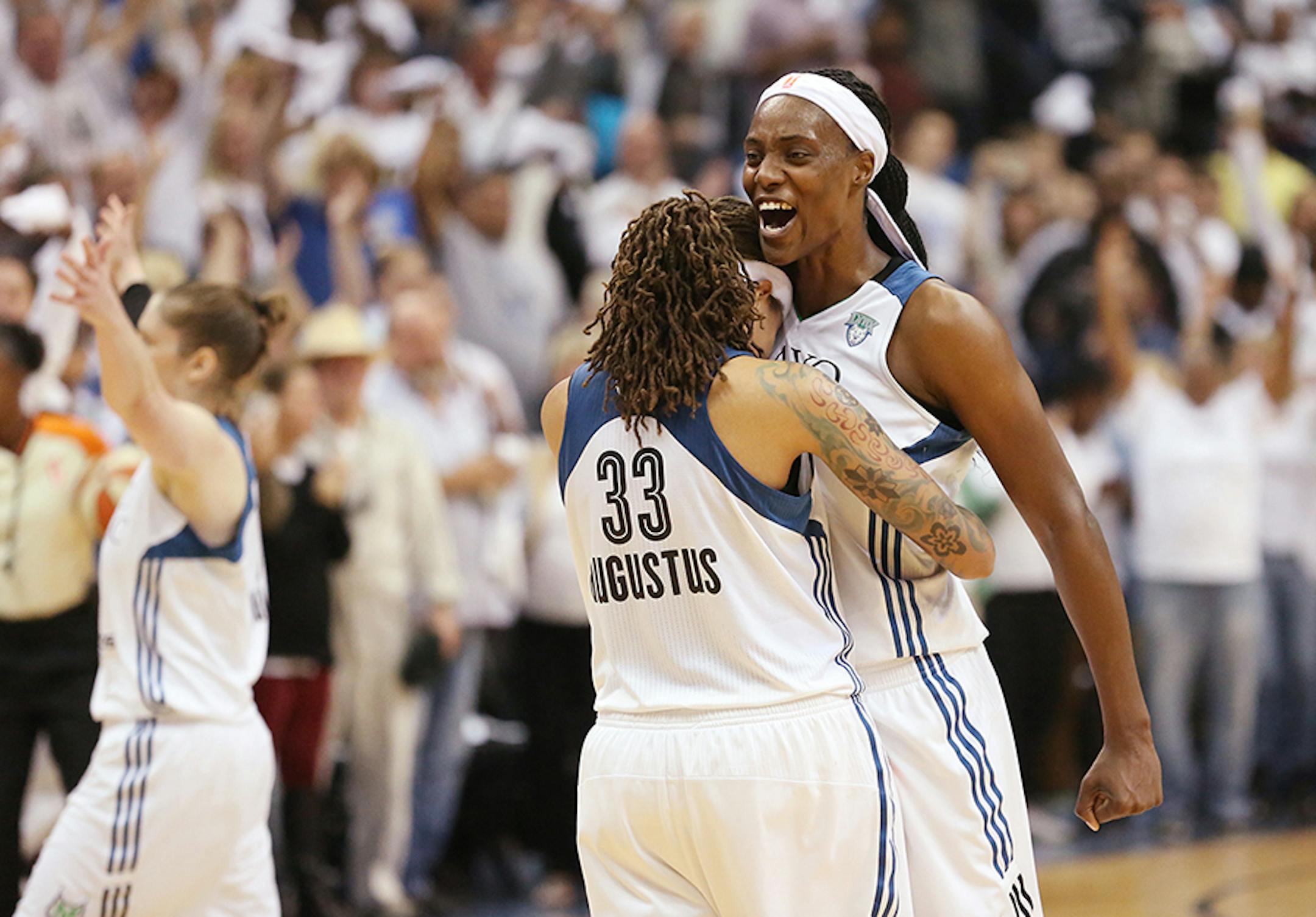 Minnesota Lynx center Sylvia Fowles (34) celebrates with Minnesota Lynx guard Seimone Augustus (33) as the clock winds down.