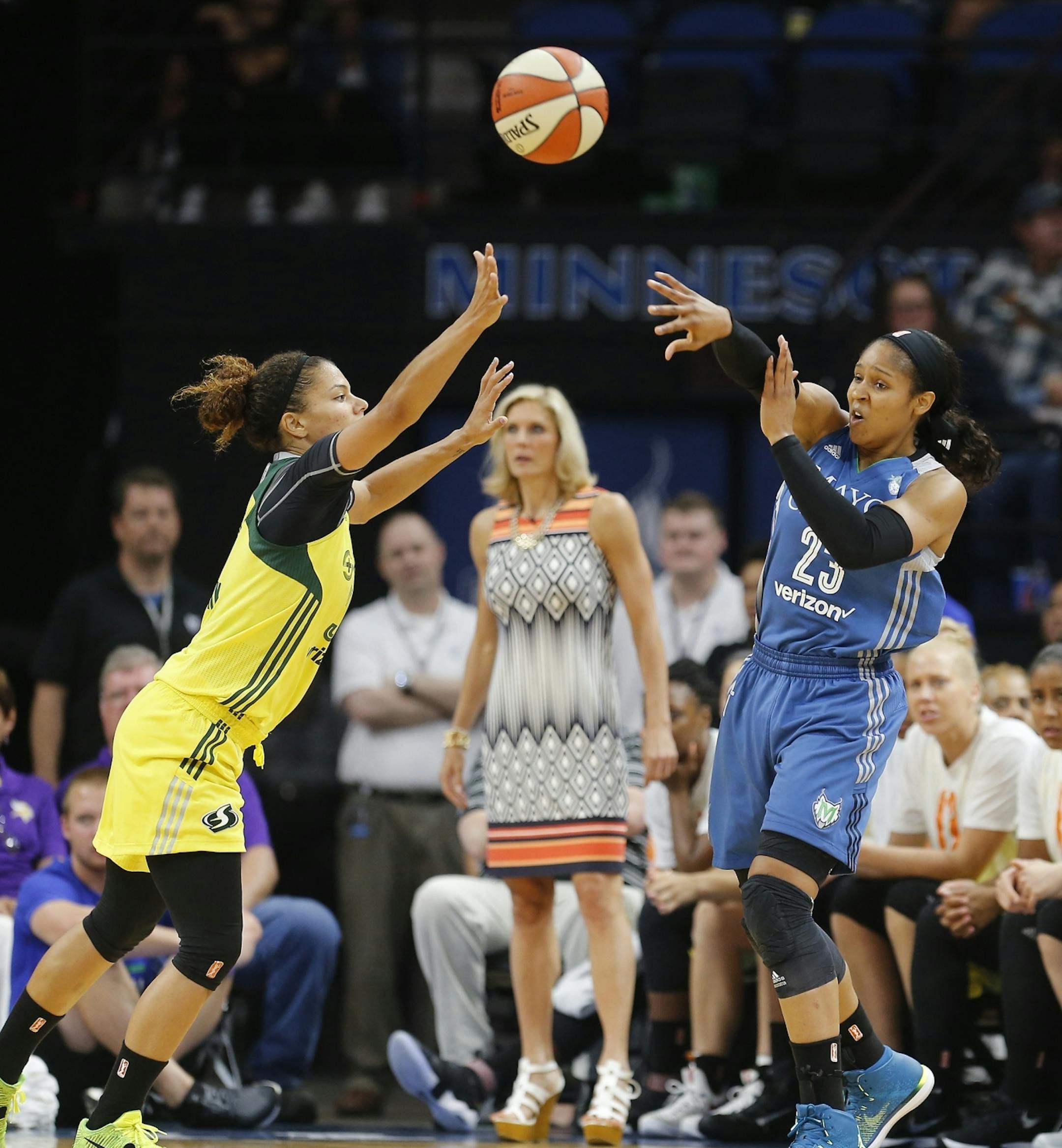 Minnesota Lynx forward Maya Moore (23) passes the ball against Seattle Storm forward Alysha Clark (32) during the first half.