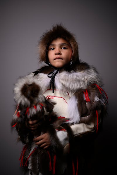 Kimimina Day, 8, stands for a portrait during "Northern Lights: A Native Nations Fashion Night."