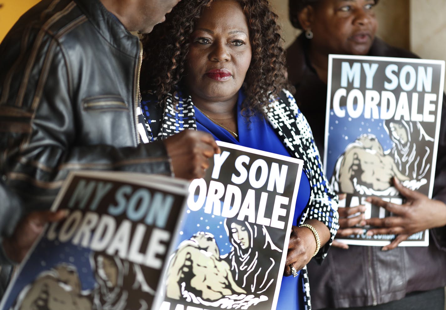 Kimberly Handy Jones flanked by Clyde McLemore left and her sister Nanette Adams held a poster of her son Cordale Handy who was killed by St. Paul Police on March 15, 2017s during press conference at the Ramsey County Courthouse Thursday April 13, 2017 in St. Paul, MN.] JERRY HOLT &#xef; jerry.holt@startribune.com