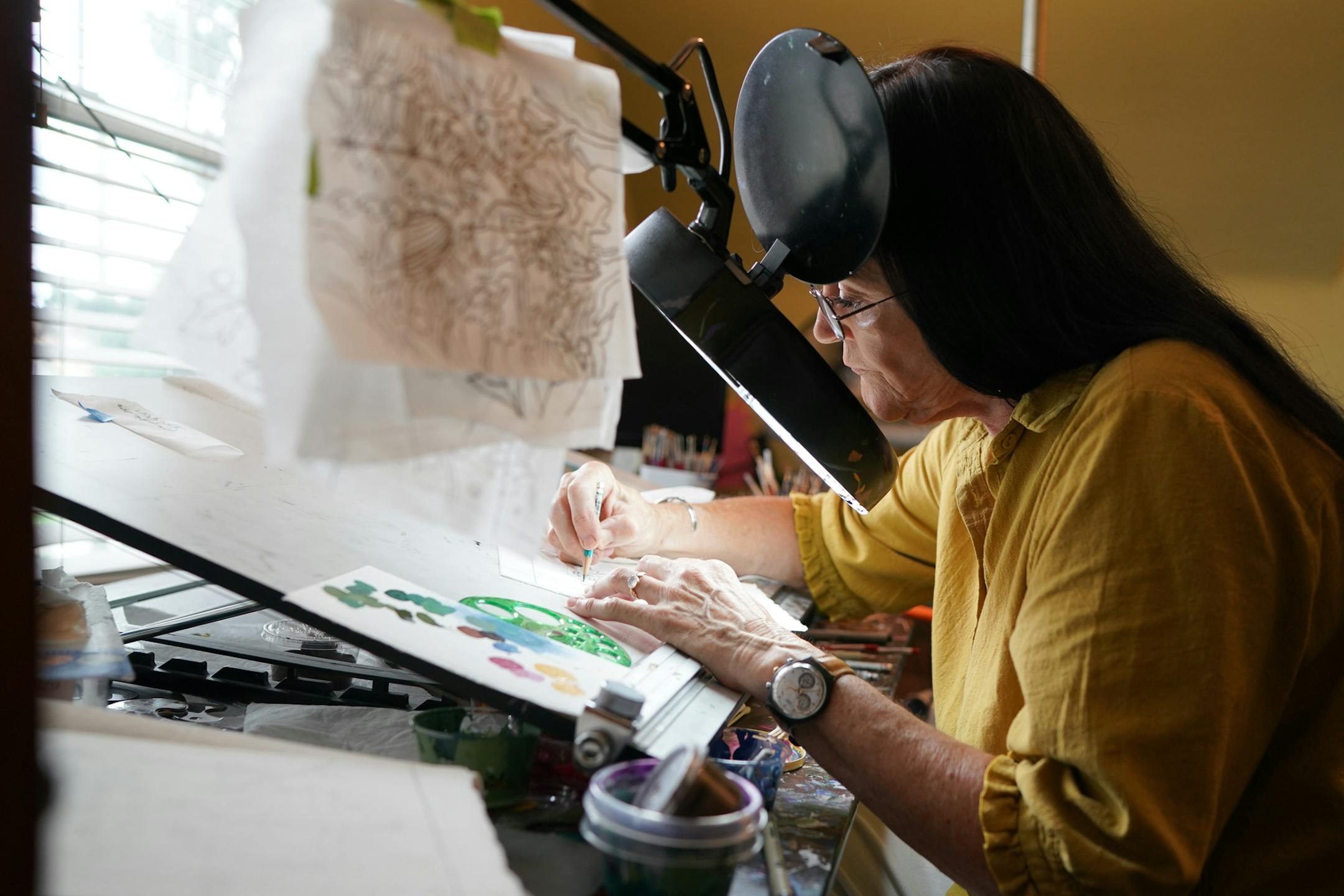 Chholing Taha worked on one of her paintings in her Anoka home. ] GLEN STUBBE • glen.stubbe@startribune.com Tuesday, August 20, 2019 A shared creative spark led a cartoonist and a painter down the aisle two weeks after they met. And it's helped keep Leslie and Chholing Taha together for 28 years. He has a new self-published book of cartoons, Off My Meds, coming out, and she has had paintings (and Native American shawls) shown at museums (including MIA) and commissioned by hospitals (Mayo,