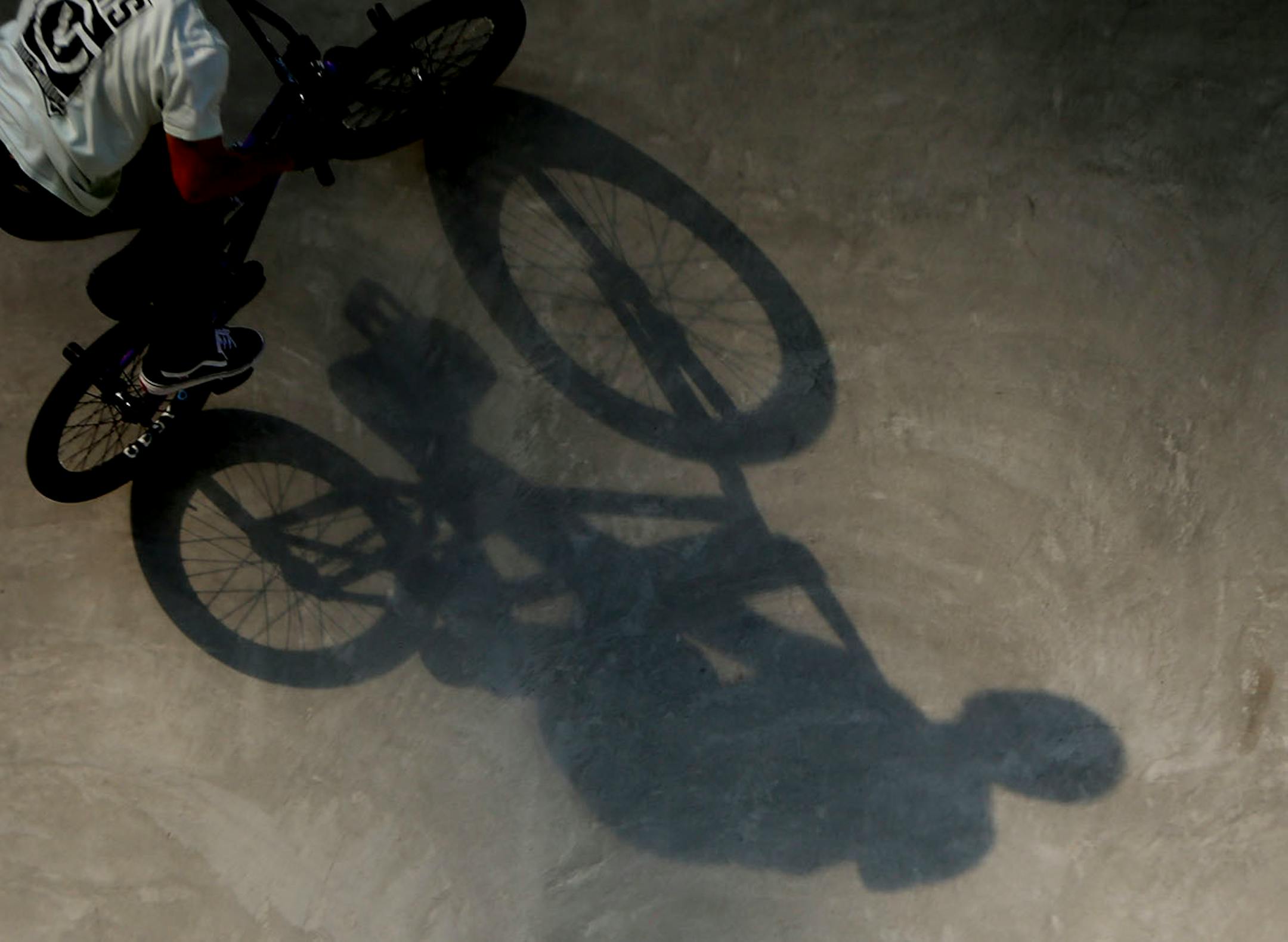 Kevin Peraza's shadow is cast on the course during one of his runs in the men's BMX park final.