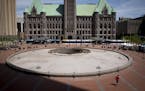 People walked by the empty water fountain in front of the Hennepin County Government Center during lunch on Friday, May 18, 2018, in Minneapolis, Minn
