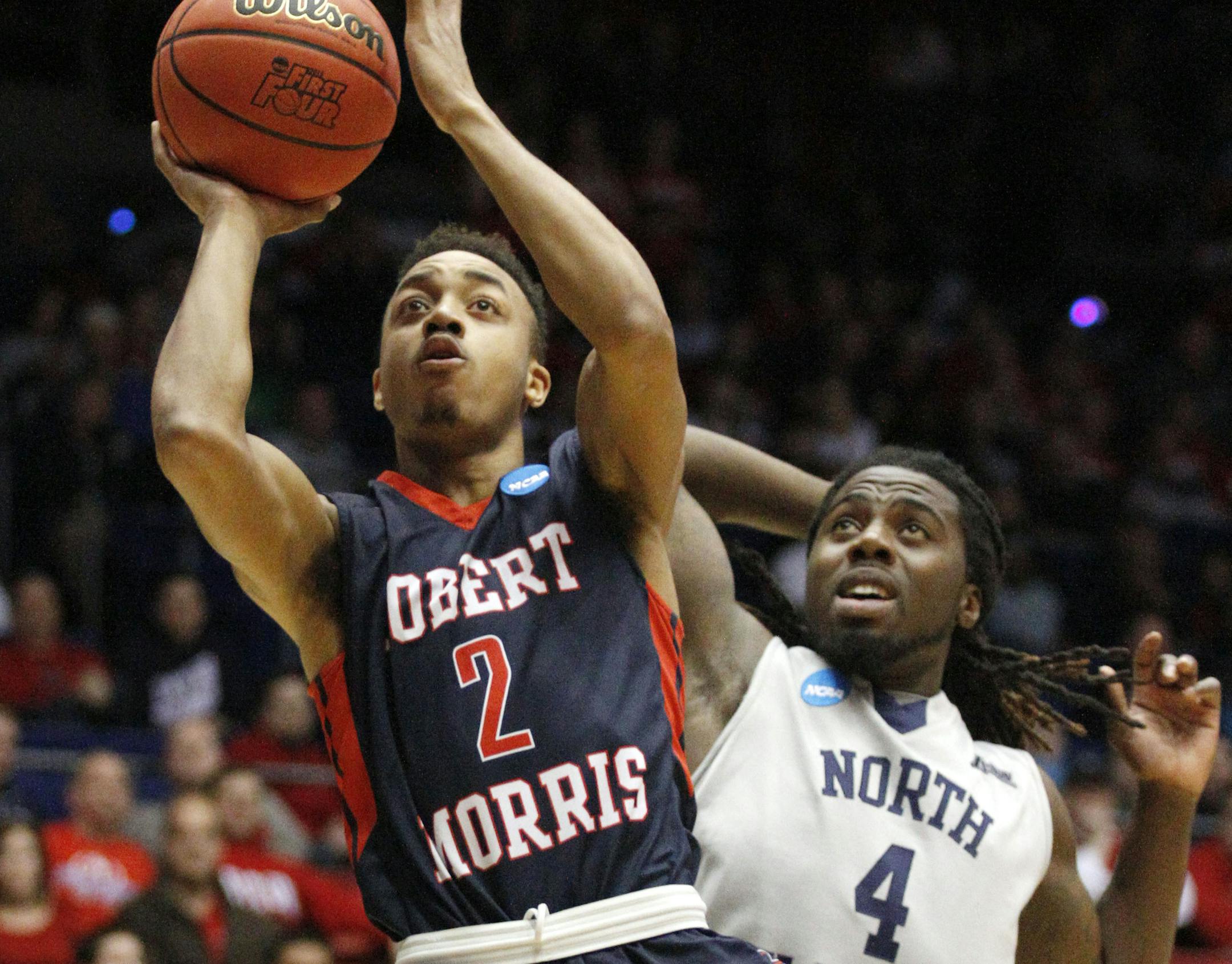 Robert Morris's Marcquise Reed (2) shoots against North Florida's Devin Wilson (4) in the first half of a first round NCAA tournament basketball game Wednesday, March 18, 2015, in Dayton, Ohio. (AP Photo/Skip Peterson)