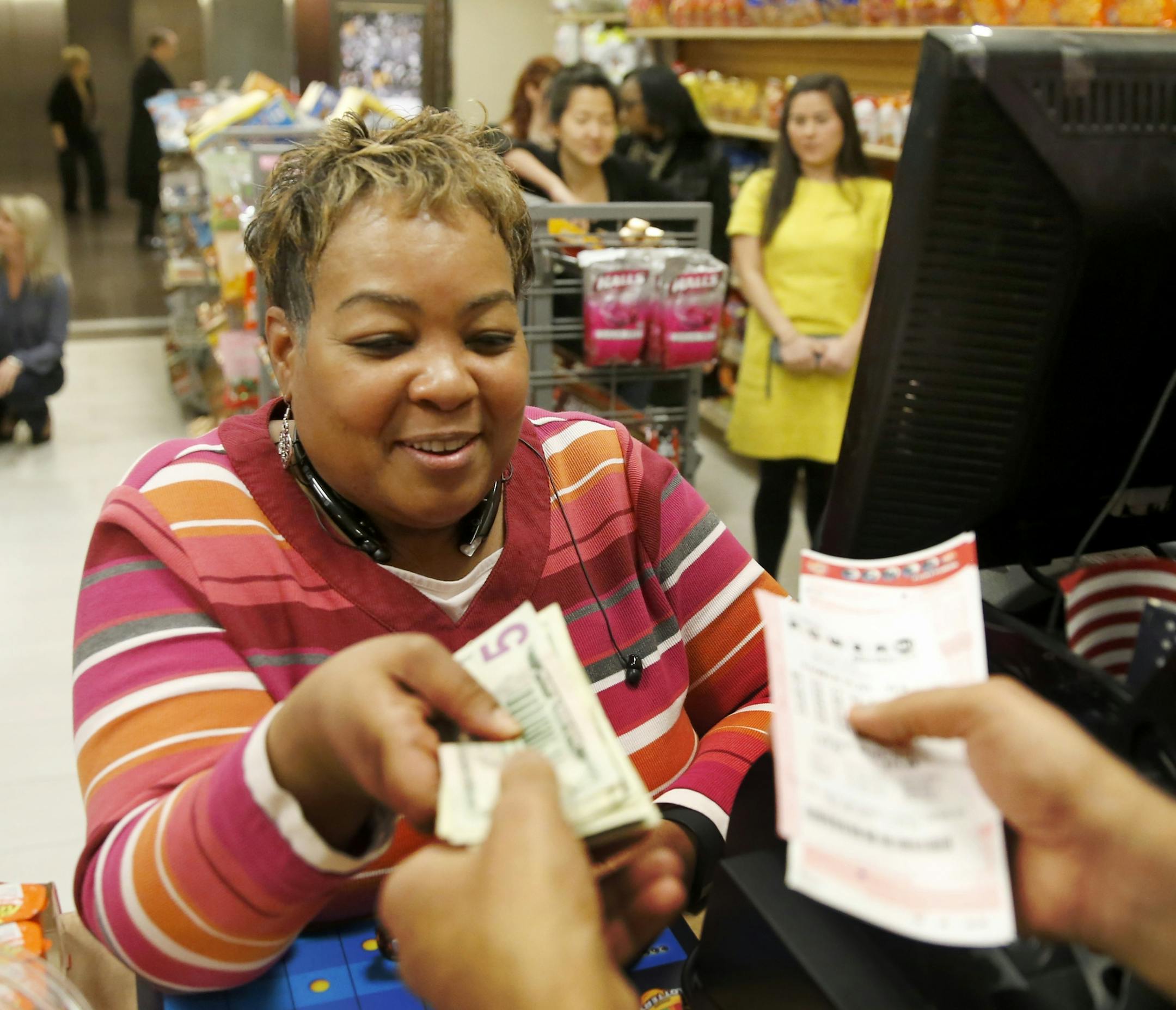 Anita Goodwin from Hammond, Ind, bought Powerball lottery tickets from Biren Shah on Friday, Jan. 8, 2016, in Chicago.