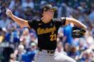Pittsburgh Pirates starting pitcher Mitch Keller throws against the Chicago Cubs during the first inning of a baseball game in Chicago, Sunday, May 19