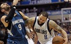 Dallas Mavericks guard Deron Williams (8) bumps Minnesota Timberwolves guard Ricky Rubio (9) as he drives toward the basket during the second half of 
