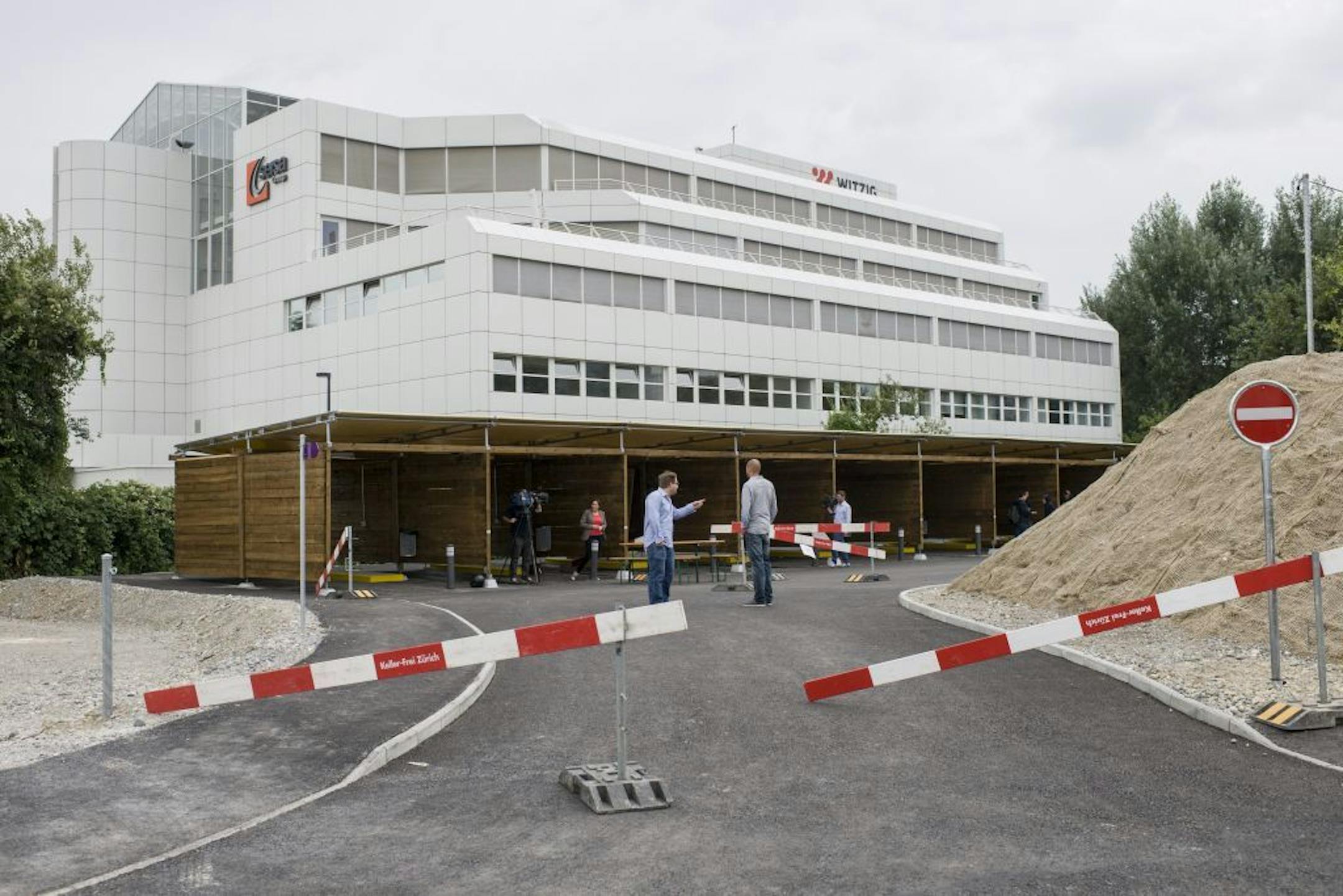 In this Saturday, Aug. 24, 2013 photo, visitors watch the wooden garage-style �sex boxes� at a construction site in Zurich, Switzerland.
