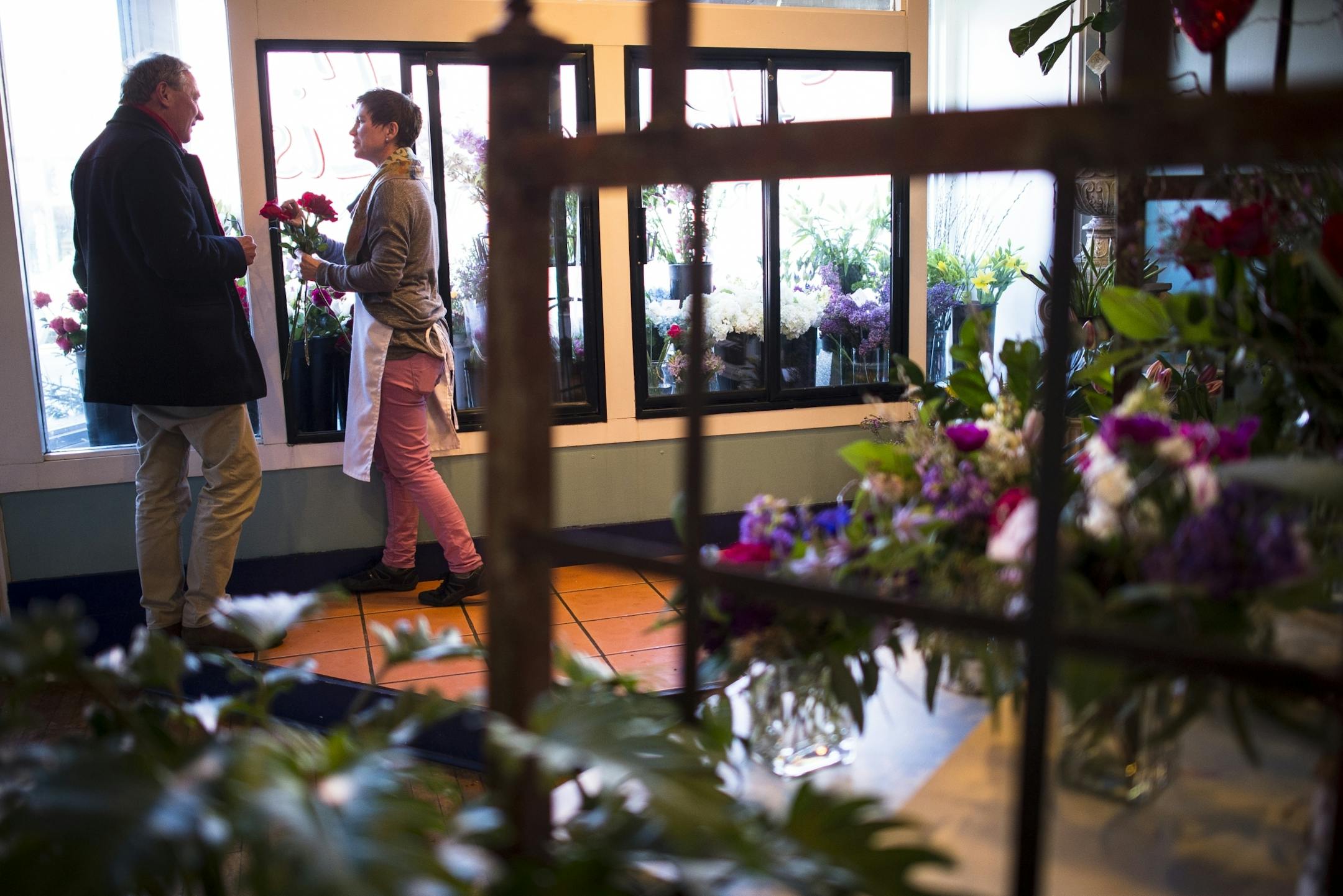 Steve Cox, of St. Paul, shopped for a bouquet of long stem red roses with the help of florist Wanda Kern at Fleur de Lis Flowers Friday afternoon. Cox has been shopping at Fleur de Lis Flowers for the past five years and Kern has been working there for a month and a half.
