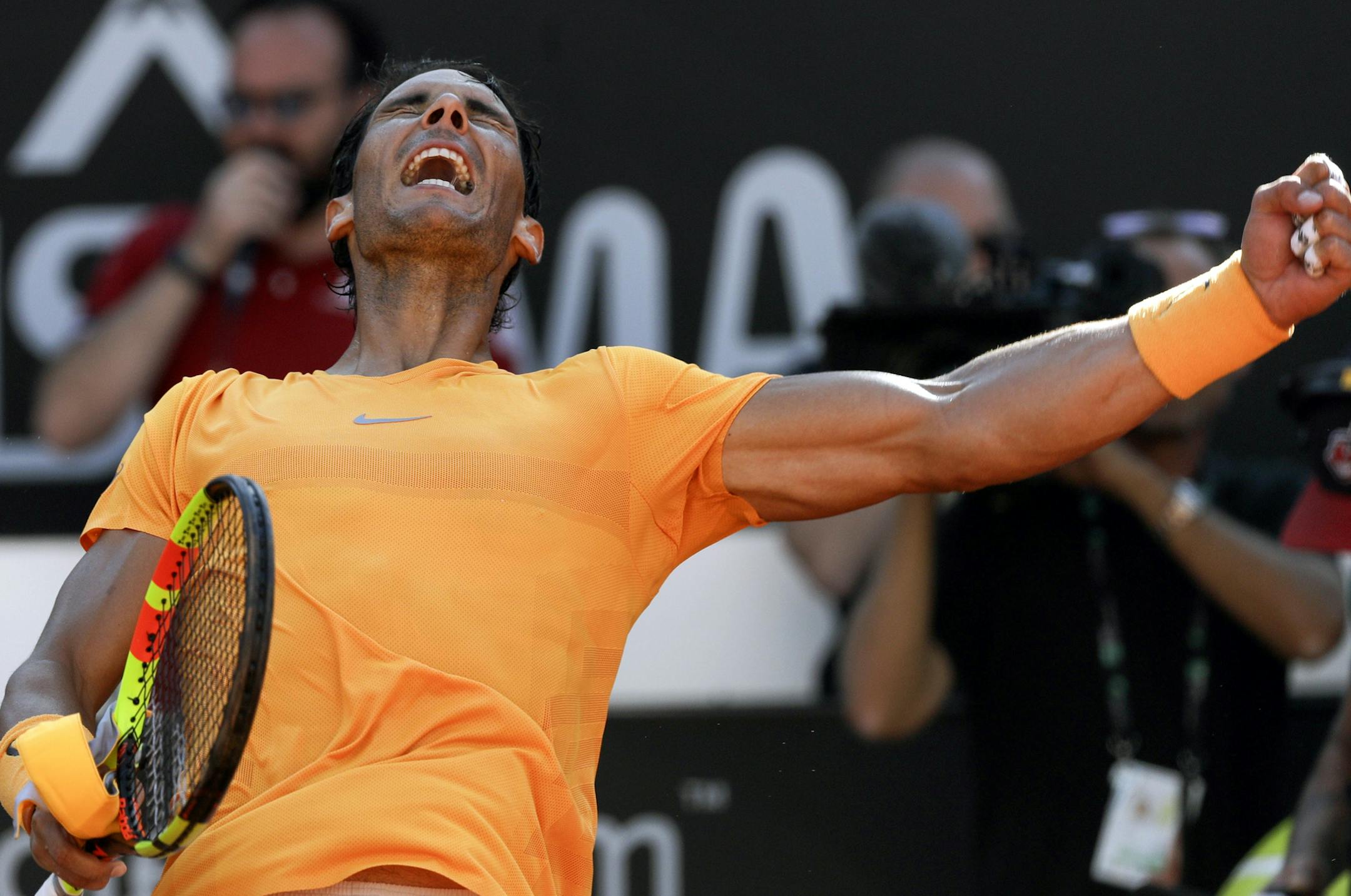 Spain's Rafael Nadal celebrates after winning his semifinal match against Serbia's Novak Djokovic at the Italian Open tennis tournament, in Rome, Saturday, May 19, 2018. Rafael Nadal was challenged in the first set by Novak Djokovic before pulling away for a 7-6 (4), 6-3 win to reach the Italian Open final on Saturday. (AP Photo/Gregorio Borgia)