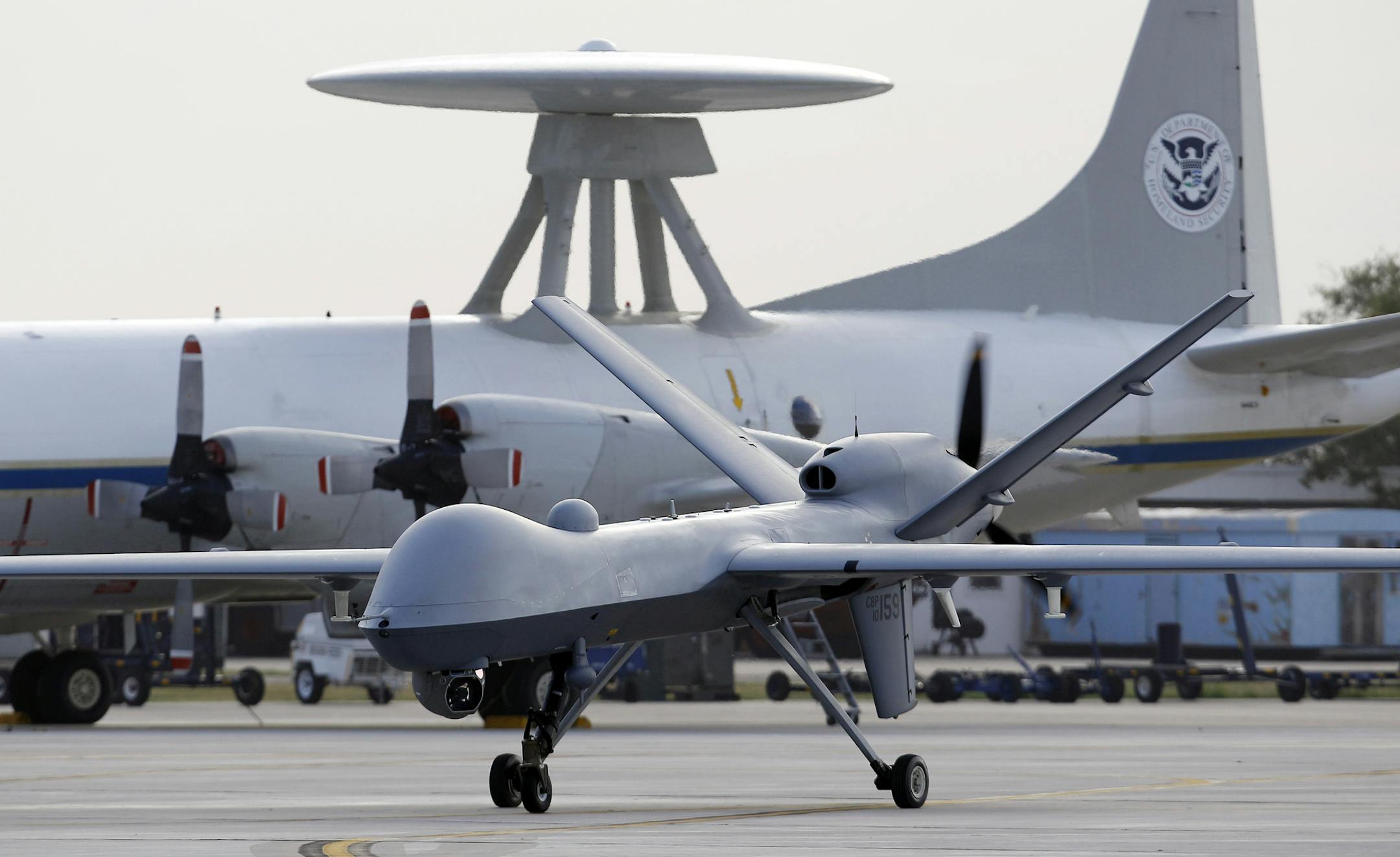 FILE - In this Nov. 8, 2011 file photo, a Predator B unmanned aircraft taxis at the Naval Air Station in Corpus Christi, Texas. The Pentagon for the first time is considering scaling back the massive build-up of drones conducted in the past few years, both to save money and to adapt to new areas of operation, such as Asia, as the Afghanistan war winds down. The downsizing would not affect the current drone campaign against terror suspects in Afghanistan, Pakistan, Yemen and elsewhere. (AP Photo/