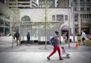 Pedestrians made their way along Nicollet Mall where the trees on the newly redesigned area are dying en masse, Wednesday, June 6, 2018 in Minneapolis