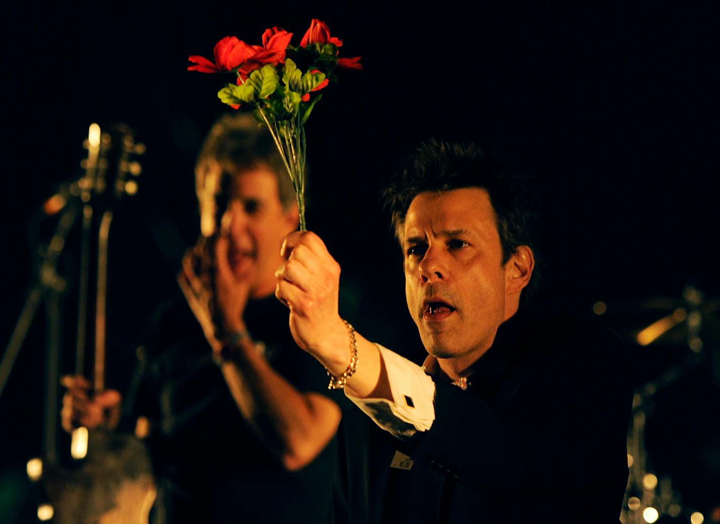 Paul Westerberg of The Replacements arrives onstage with a bouquet of flowers before their performance at the 2014 Coachella Music and Arts Festival on Friday, April 11, 2014, in Indio, Calif.