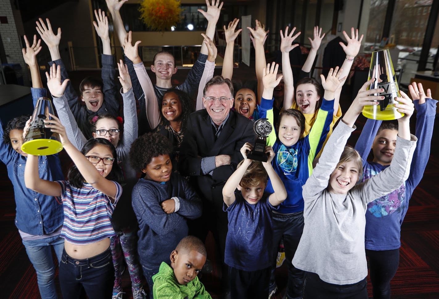 Artistic director Peter Brosius and some Children's Theatre Company students showed off a few of the Minneapolis theater's awards.