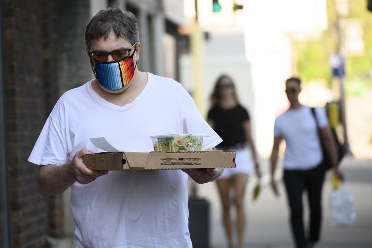 Mark Berman walked back to his North Loop home with a pizza and salad from Black Sheep Wednesday night. "I would not go to any place that offers in house dining. I would not even eat outside in a patio setting," said Berman, who is still weary of public settings due to the COVID-19 pandemic. "I follow the science, I don't follow the politics."