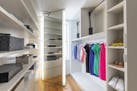 Boxes and baskets help keep this large closet modern and organized. (Design Recipes/TNS)