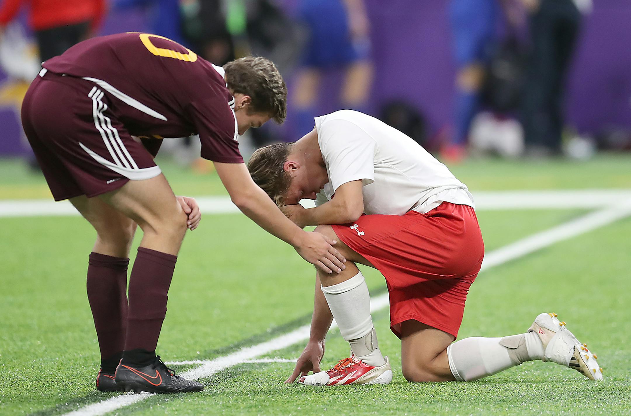 Northfield's Landon Coleman comforts Mankato West's Jacob Makela after defeating them 3-0 after their matchup at the Minnesota State High School League Class 2A boys' soccer semifinals at US Bank Stadium, Monday, October 31, 2016 in Minneapolis, MN. ] (ELIZABETH FLORES/STAR TRIBUNE) ELIZABETH FLORES • eflores@startribune.com