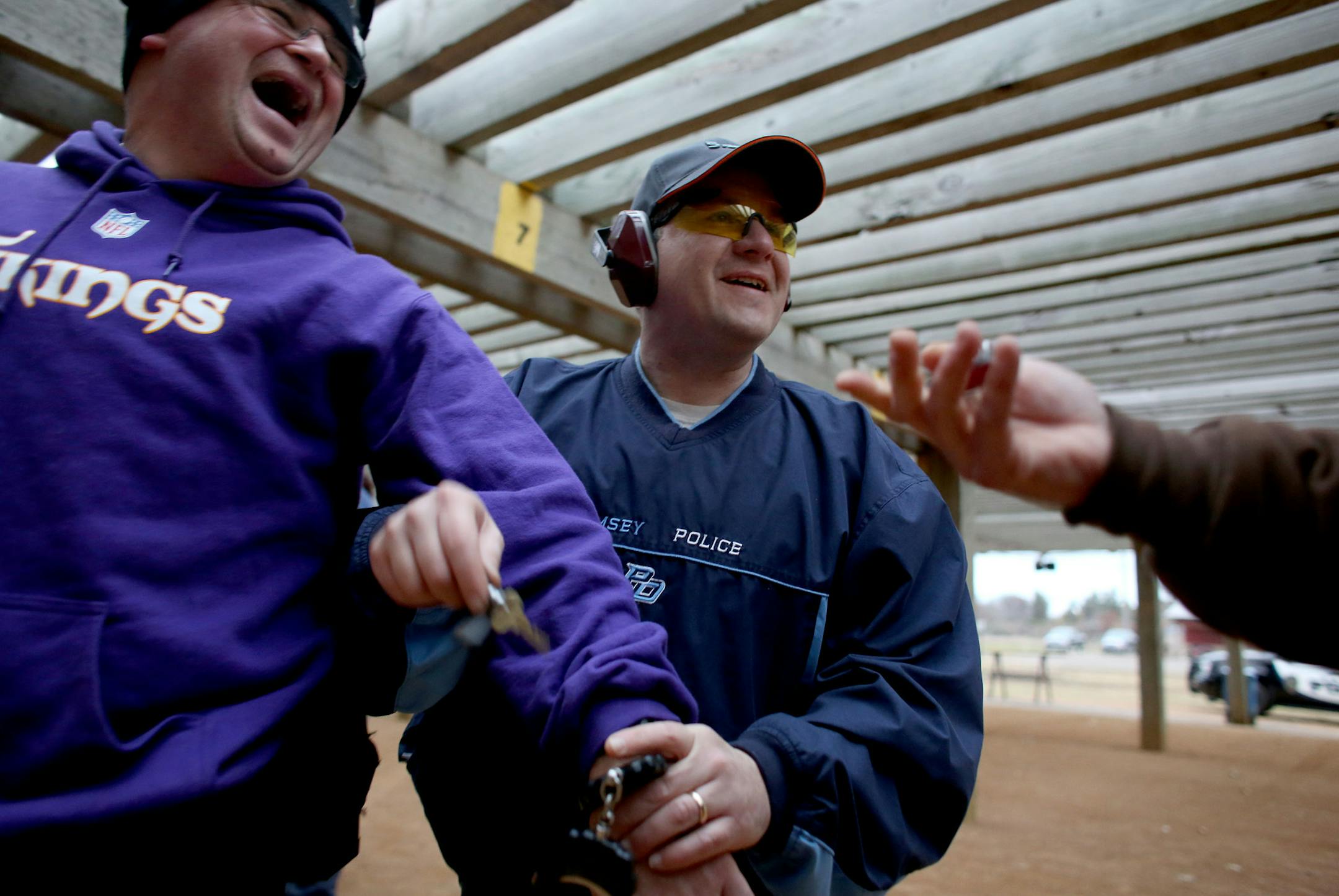 New Ramsey police chief Jeff Katers joked around with officer Cory Gardner as Katers tried to handcuff Gardner as they prepared for a drill. ] (KYNDELL HARKNESS/STAR TRIBUNE) kyndell.harkness@startribune.com At the Anoka Sheriff range in Andover Min., Thursday, October 30, 2014.